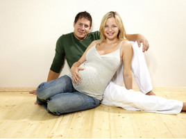 Expectant parents sitting on the floor