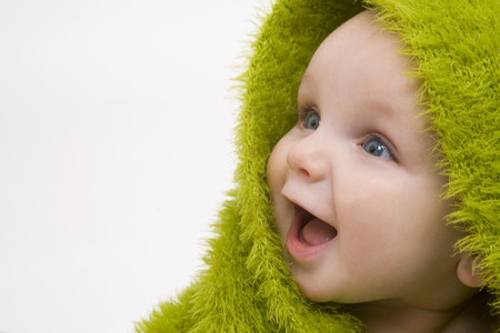 Baby with a green blanket on its head